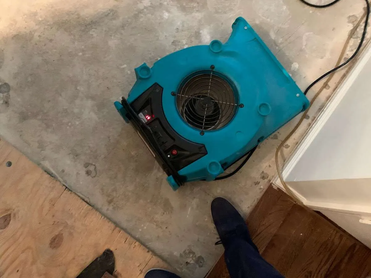 Air mover drying subfloor during Commercial Water Damage Restoration in Franklin Lakes
